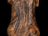 an old statue of a man holding a baby in his arms