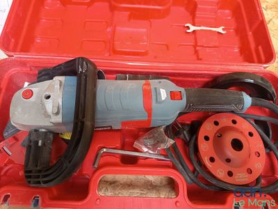 a red box with a tool in it on a table
