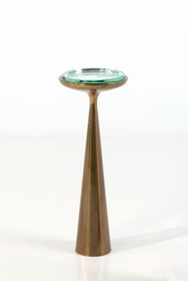 a small table with a glass top on a white surface