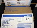 two boxes of brother printer cartridges sitting on a table