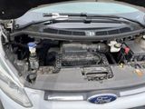 a car engine with its hood open on the street