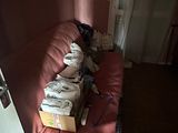 a couch with a box of diapers on it in the corner of a room