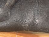 a close up of a black elephant statue on a table