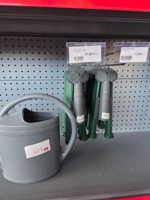 a watering can sitting on a shelf in a store