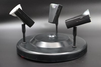 three lamps that are sitting on top of a stand