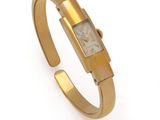 a close up of a gold wrist watch on a white background