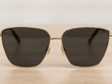a pair of sunglasses sitting on top of a wooden table