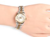 an image of a woman ' s wrist with a watch on it