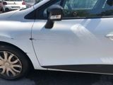 a small white car parked on the side of the road
