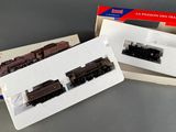 two miniature trains sitting in a box on a table