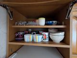 un meuble en bois sur lequel sont posés de la vaisselle et des tasses