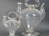 three glass vases sitting next to each other on a table
