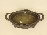 a metal bowl with a handle on the wall