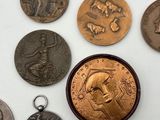 some coins are sitting on a table with a coin in front of them