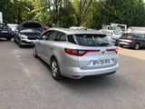 a silver car parked in a parking lot with other cars in the background