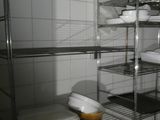 many shelves with dishes on them in a kitchen
