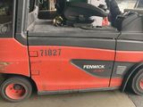 a red forklift truck parked in a garage
