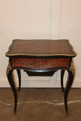 an image of a small table with a red and black top
