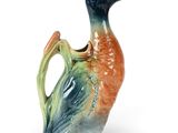 a ceramic duck that is sitting on the ground