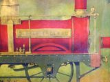 a painting of a red train on display in a museum