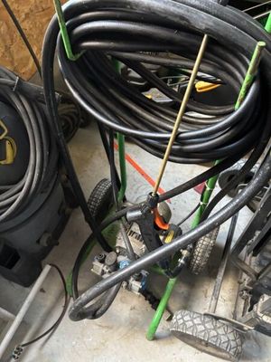 a pile of hoses and other equipment in a garage