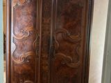 a large wooden armoire in the corner of a room