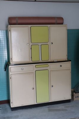 an old refrigerator in the corner of a room with blue tiles