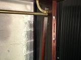 a wooden shelf with a metal bar attached to it