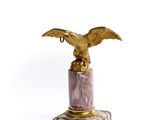 a statue of an eagle that is on a pedestal