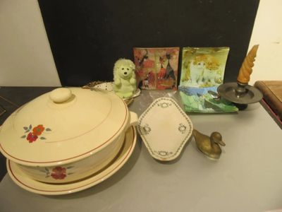 a table with a bowl, plate, spoon, and other items on it