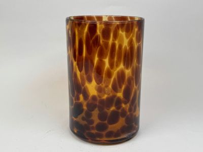 a glass with a brown and black pattern on it