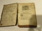 an old book that is open on a table