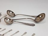 many spoons and spoon spoons laid out on a table