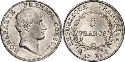 a silver coin with a portrait of a man on it