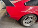 a red car that is parked in a garage