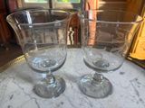 two empty wine glasses sitting on a marble table
