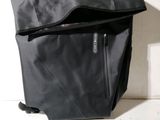 a black bag with a zipper on it sitting on the floor