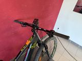 a bike parked against a red wall in a room