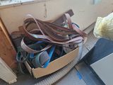 a lot of belts in a box on the floor