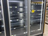 two refrigerators that are sitting in the middle of a store