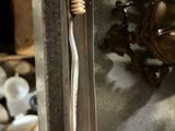 a toothbrush that is sitting in a metal container