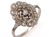 an image of a silver ring with a diamond center