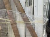 several pieces of wood are wrapped in plastic and sitting on a pallet