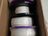 a box full of white and purple rope in a cardboard box