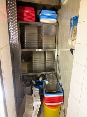 a small kitchen with many dishes on the shelves