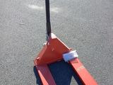 a fork lifter sitting in the middle of a parking lot