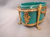 a blue bowl with gold decoration on it sitting on a table