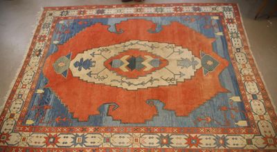 an orange and blue area rug with a design on it