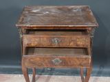 a small wooden table with two drawers on top of it