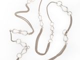 silver chain necklace and bracelet set on a white background